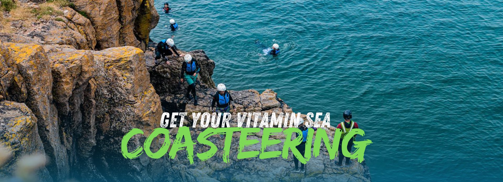 Cliff jumping into the sea while coasteering